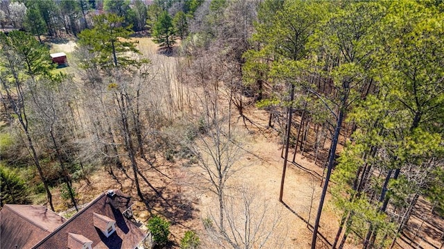 birds eye view of property with a wooded view