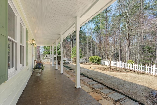 view of patio with a porch and fence