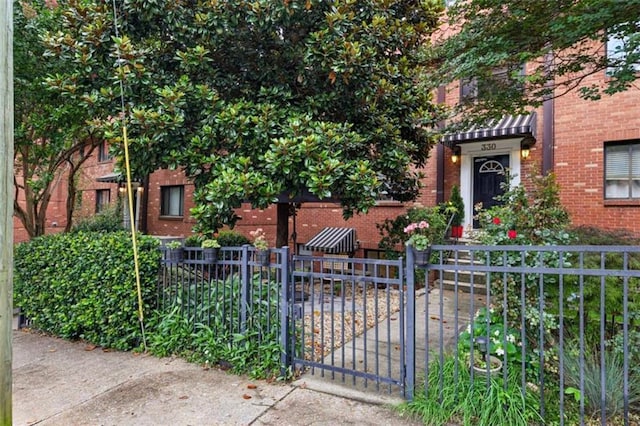 330 3rd St Apt 1, Atlanta, GA 30308 - view of front of home featuring brick siding, a fenced front yard, and a gate
