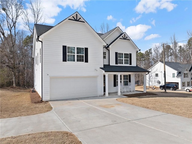 traditional-style home featuring covered porch, driveway, roof with shingles, and a garage