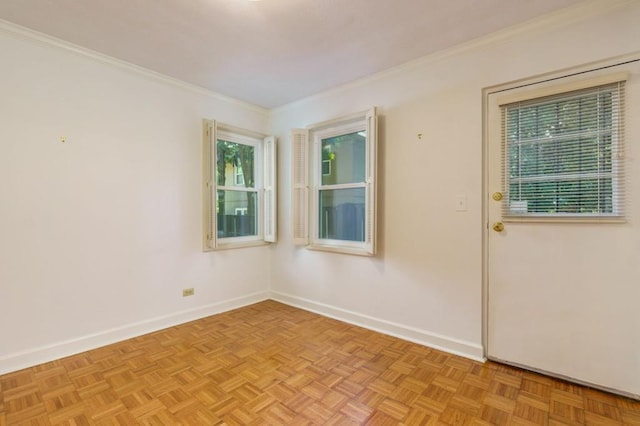 empty room featuring light parquet floors and crown molding