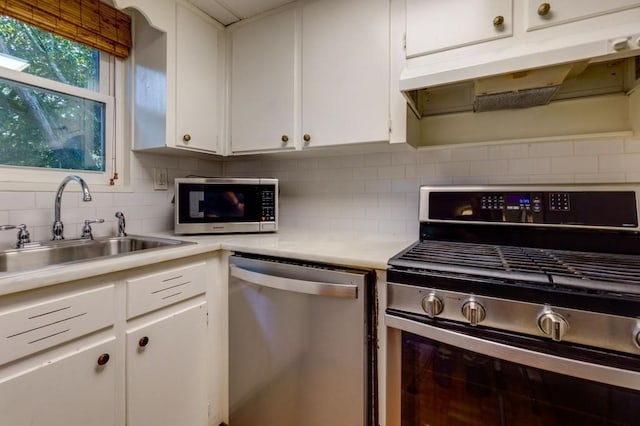 kitchen featuring white cabinetry, appliances with stainless steel finishes, sink, and tasteful backsplash