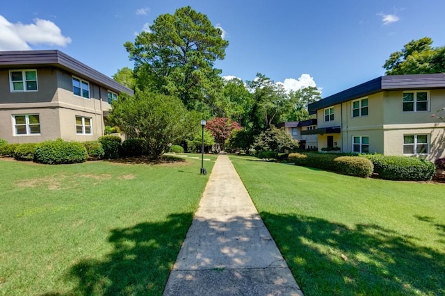 view of home's community with a lawn