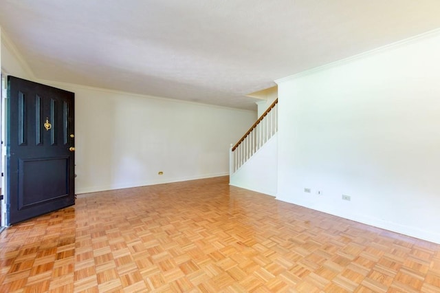 unfurnished room with light parquet floors and ornamental molding