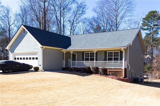 view of front of house featuring a garage, a front yard, and covered porch