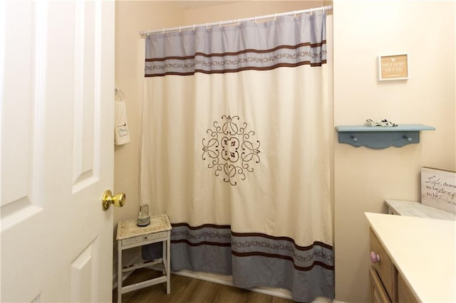 bathroom featuring vanity, curtained shower, and hardwood / wood-style floors