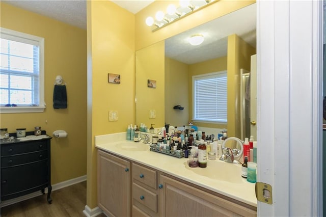 bathroom featuring hardwood / wood-style flooring, a textured ceiling, and vanity