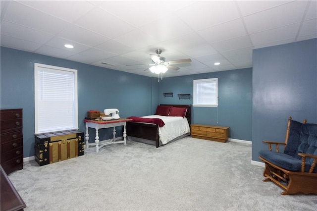 bedroom featuring carpet flooring, a paneled ceiling, and ceiling fan