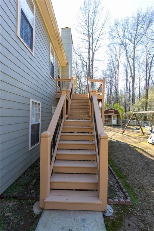 wooden terrace featuring a playground