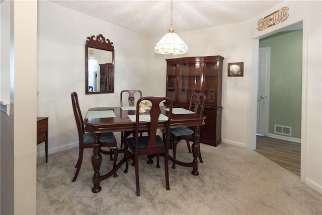 dining room featuring light carpet