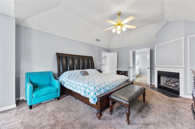 carpeted bedroom featuring a fireplace with flush hearth, visible vents, vaulted ceiling, and baseboards
