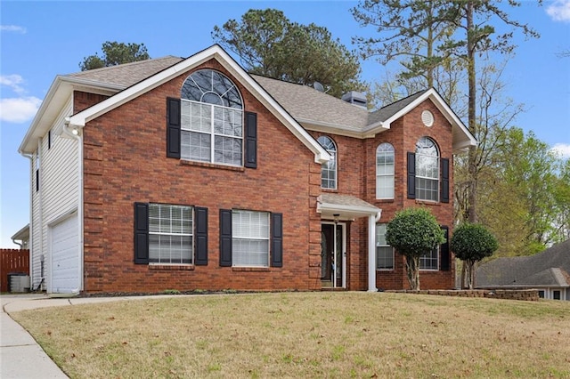 traditional-style home with a front yard, brick siding, driveway, roof with shingles, and an attached garage
