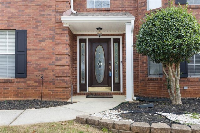 entrance to property with brick siding