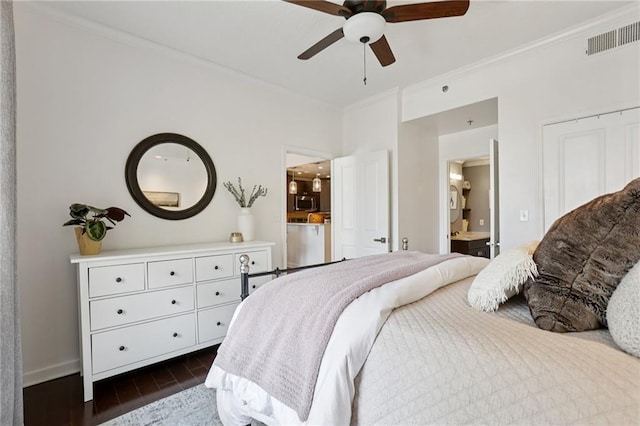 1101 Juniper St NE Unit 1012, Atlanta, GA 30309 - bedroom with dark wood-style floors, ornamental molding, connected bathroom, baseboards, and ceiling fan