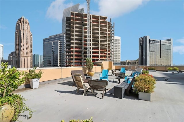 1101 Juniper St NE Unit 1012, Atlanta, GA 30309 - view of patio featuring a skyline view and a fire pit