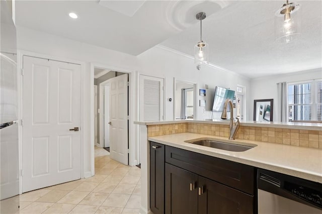 1101 Juniper St NE Unit 1012, Atlanta, GA 30309 - kitchen featuring dishwasher, a sink, light countertops, hanging light fixtures, and light tile patterned floors