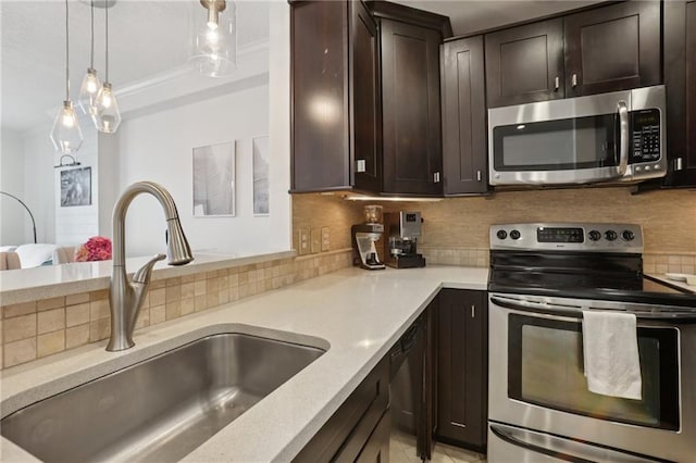 1101 Juniper St NE Unit 1012, Atlanta, GA 30309 - kitchen with appliances with stainless steel finishes, a sink, dark brown cabinets, tasteful backsplash, and crown molding