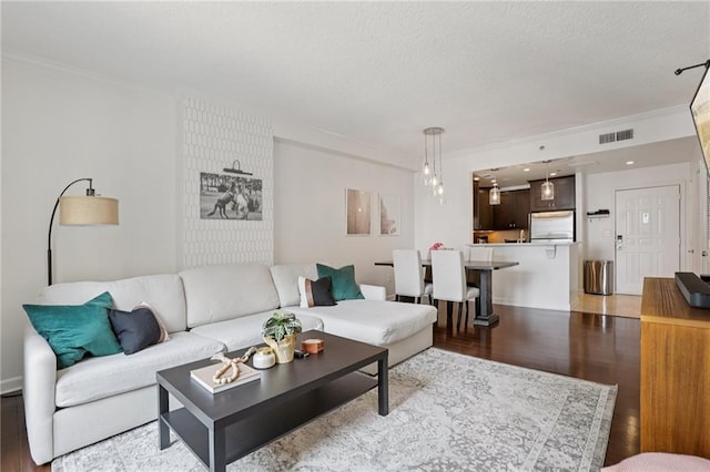 1101 Juniper St NE Unit 1012, Atlanta, GA 30309 - living area with ornamental molding, light wood-style floors, and a textured ceiling