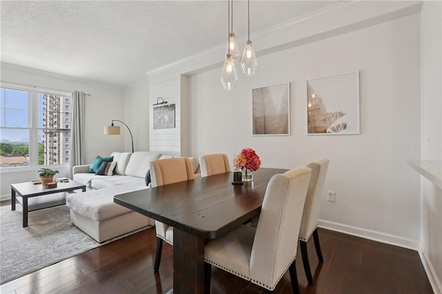 1101 Juniper St NE Unit 1012, Atlanta, GA 30309 - dining room with crown molding, dark wood-style flooring, a textured ceiling, and baseboards