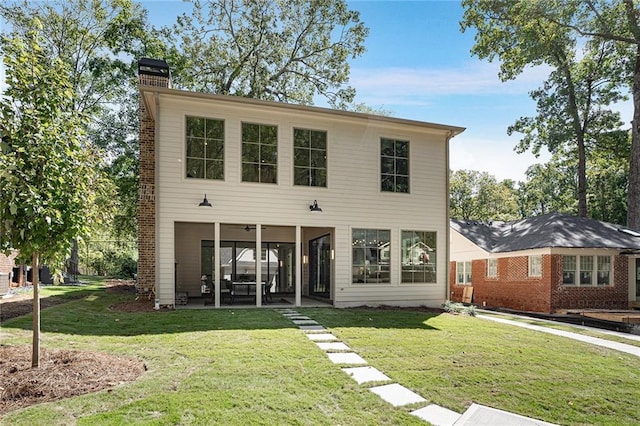 rear view of house with a lawn and a patio area