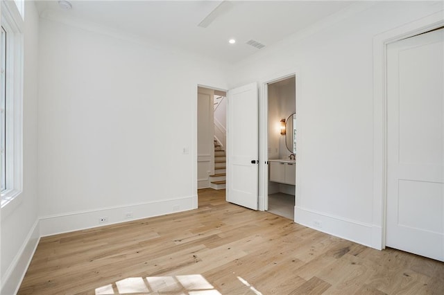 unfurnished bedroom with ensuite bathroom, ceiling fan, light hardwood / wood-style floors, and crown molding