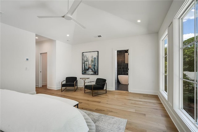 bedroom with ceiling fan, light wood-type flooring, and connected bathroom