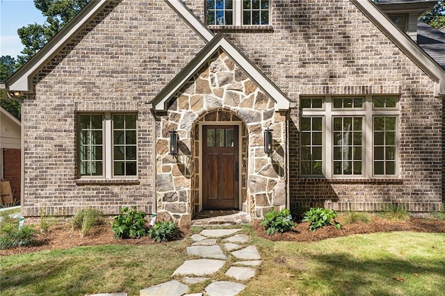 entrance to property with a lawn