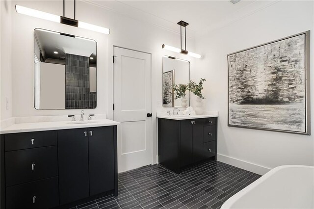 bathroom with a tub to relax in, tile patterned flooring, vanity, and ornamental molding