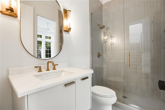 bathroom with vanity, toilet, and a shower with shower door