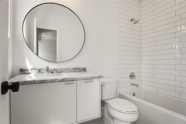 full bathroom with vanity, tiled shower / bath combo, and toilet