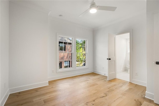 empty room featuring light wood-type flooring, ceiling fan, and crown molding