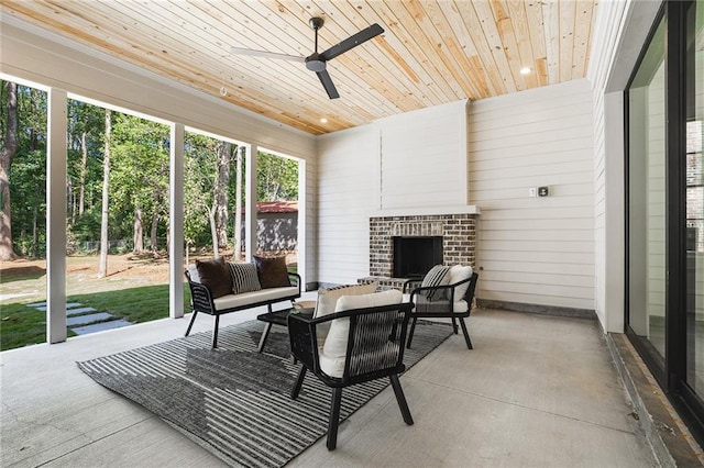 sunroom / solarium featuring an outdoor brick fireplace, ceiling fan, and wooden ceiling