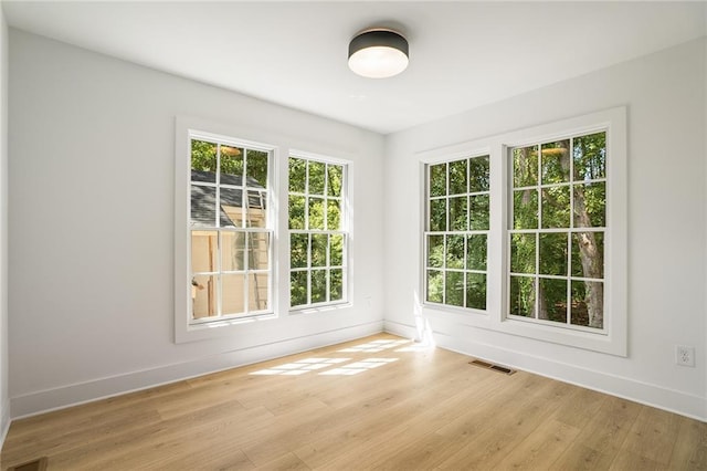 unfurnished room with light hardwood / wood-style floors