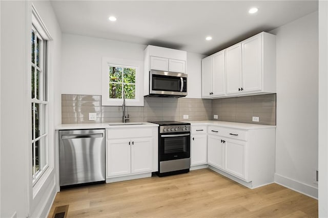 kitchen with white cabinets, sink, and stainless steel appliances