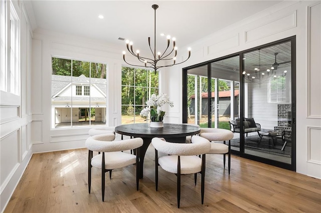 sunroom / solarium featuring a notable chandelier and a healthy amount of sunlight