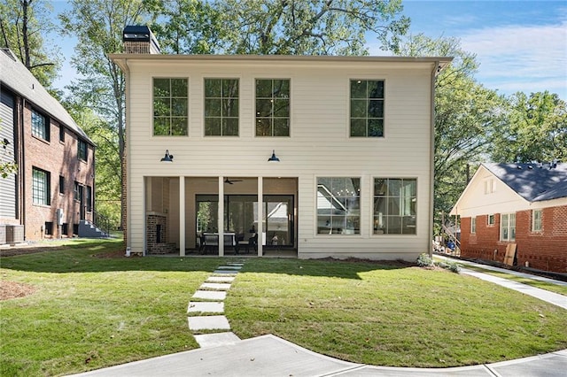 back of house with a lawn and central AC unit