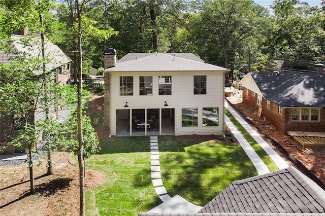 rear view of house with a yard