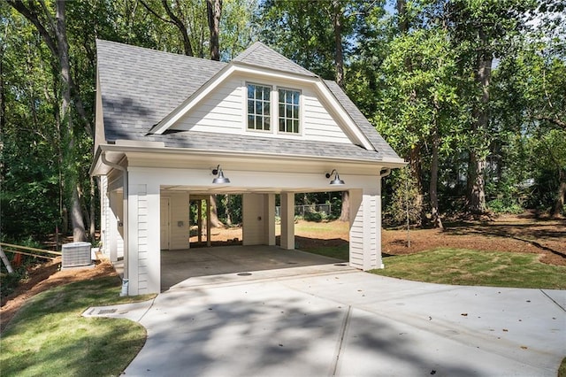 view of front of property featuring a carport and central air condition unit