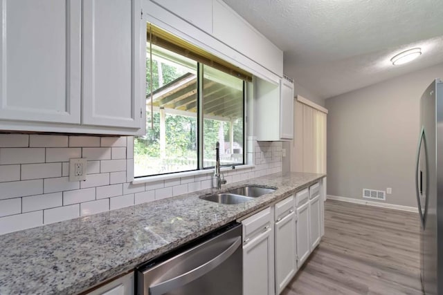 1353 Litchfield Ct, Snellville, GA 30078 - kitchen featuring stainless steel appliances, a sink, baseboards, white cabinets, and a textured ceiling