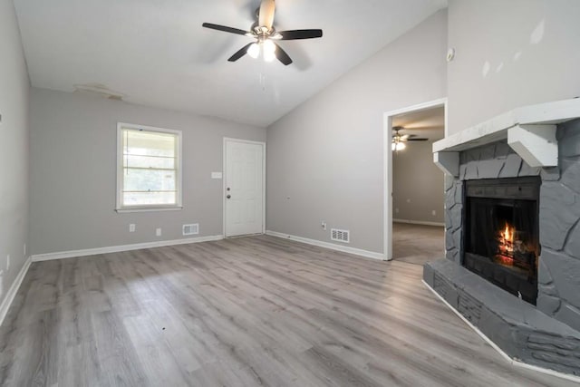 1353 Litchfield Ct, Snellville, GA 30078 - unfurnished living room featuring lofted ceiling, a ceiling fan, wood finished floors, a warm lit fireplace, and baseboards