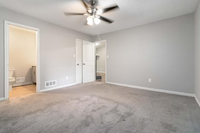 1353 Litchfield Ct, Snellville, GA 30078 - unfurnished bedroom featuring carpet floors, baseboards, connected bathroom, and ceiling fan