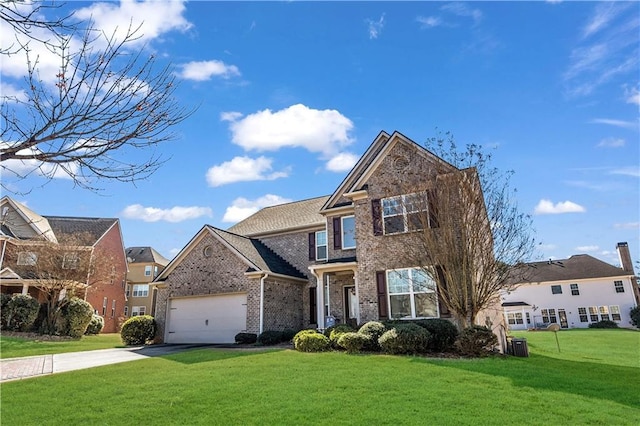 view of front of home with a garage and a front lawn