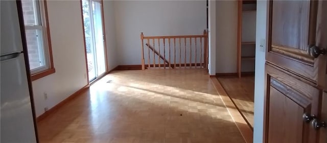 unfurnished room featuring a wealth of natural light and light hardwood / wood-style flooring