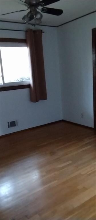 spare room with hardwood / wood-style floors