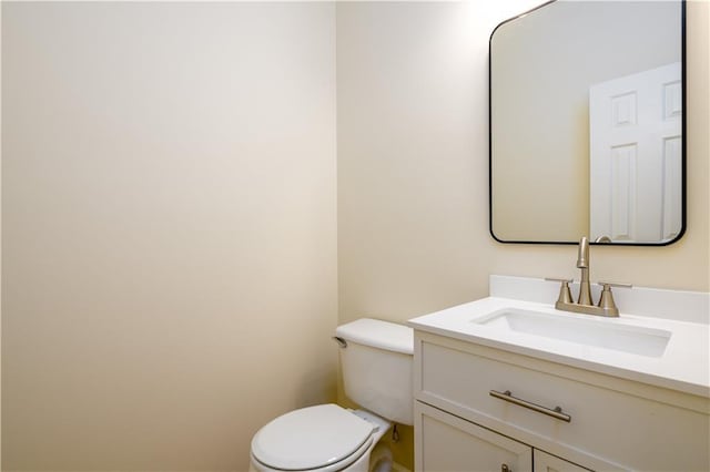 half bathroom with toilet and vanity