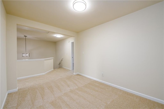 carpeted empty room featuring baseboards