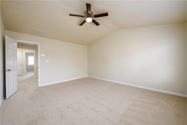 empty room with light carpet, baseboards, attic access, ceiling fan, and vaulted ceiling