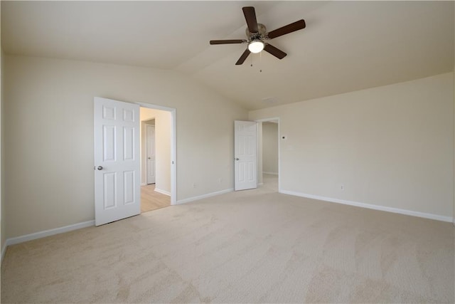 unfurnished bedroom with a ceiling fan, lofted ceiling, light colored carpet, and baseboards