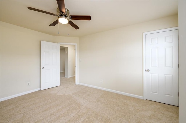 unfurnished bedroom with baseboards and light carpet