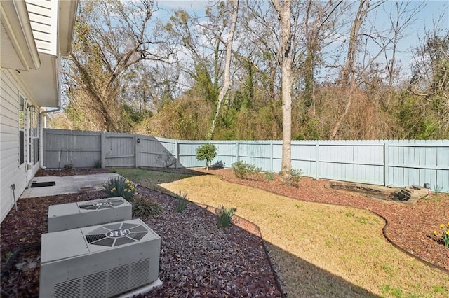 view of yard with a fenced backyard and central AC unit